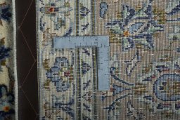 Backside of handmade New Nain rug showing knot structure and weave density