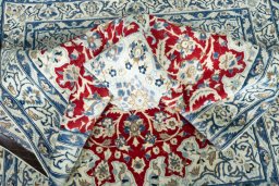 Surface texture of 2000s Nain rug with natural Wool and intricate pattern