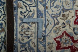 Backside of handmade 2000s Nain rug showing knot structure and weave density