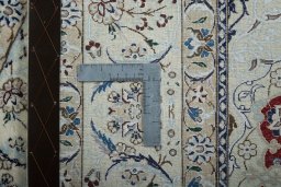 Backside of handmade New Nain rug showing knot structure and weave density