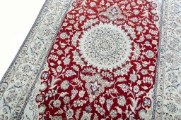 Backside of handmade New Nain rug showing knot structure and weave density