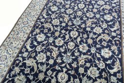 Backside of handmade New Nain rug showing knot structure and weave density