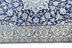 Corner detail of 2000s Nain rug showing border pattern and Wool pile