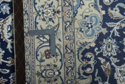 Backside of handmade 2000s Nain rug showing knot structure and weave density