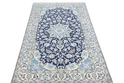 Surface texture of 2000s Nain rug with natural Wool and intricate pattern