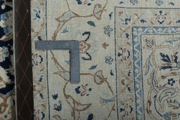 Backside of handmade 2000s Nain rug showing knot structure and weave density