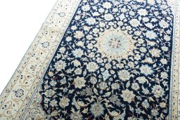 Backside of handmade 2000s Nain rug showing knot structure and weave density