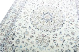 Backside of handmade New Nain rug showing knot structure and weave density