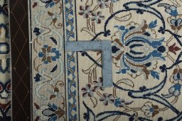 Backside of handmade New Nain rug showing knot structure and weave density