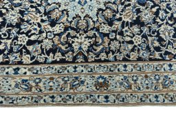 Corner detail of 2000s Nain rug showing border pattern and Wool pile
