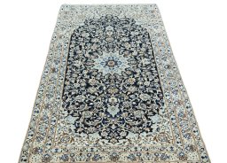 Surface texture of 2000s Nain rug with natural Wool and intricate pattern