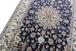 Backside of handmade New Nain rug showing knot structure and weave density