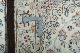 Backside of handmade New Nain rug showing knot structure and weave density
