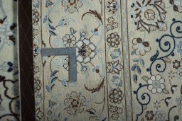 Backside of handmade New Nain rug showing knot structure and weave density