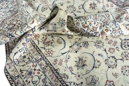 Surface texture of 2000s Nain rug with natural Wool and intricate pattern