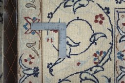 Backside of handmade 2000s Nain rug showing knot structure and weave density