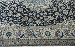 Corner detail of 2000s Nain rug showing border pattern and Wool pile