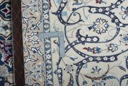 Backside of handmade New Nain rug showing knot structure and weave density