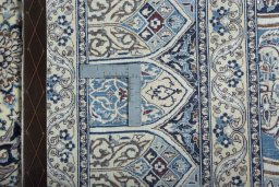 Backside of handmade New Nain rug showing knot structure and weave density