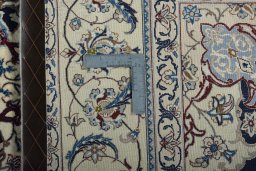 Backside of handmade New Nain rug showing knot structure and weave density