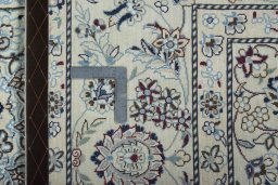Backside of handmade New Nain rug showing knot structure and weave density