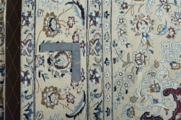 Backside of handmade New Nain rug showing knot structure and weave density
