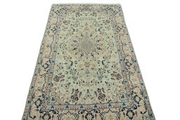 Surface texture of 2000s Nain rug with natural Wool and intricate pattern
