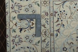 Backside of handmade 2000s Nain rug showing knot structure and weave density