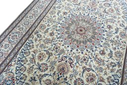 Backside of handmade New Nain rug showing knot structure and weave density