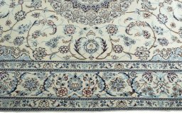 Corner detail of 2000s Nain rug showing border pattern and Wool pile