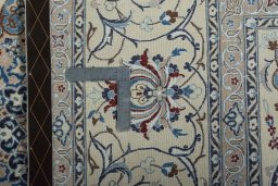 Backside of handmade New Nain rug showing knot structure and weave density