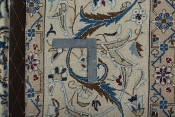 Backside of handmade 2000s Nain rug showing knot structure and weave density