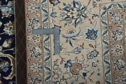 Backside of handmade 1970s Nain rug showing knot structure and weave density
