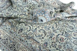 Surface texture of 2000s Nain rug with natural Wool and intricate pattern