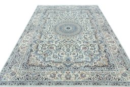 Surface texture of 2000s Nain rug with natural Wool and intricate pattern