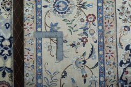 Backside of handmade 2000s Nain rug showing knot structure and weave density