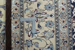 Backside of handmade 2000s Nain rug showing knot structure and weave density