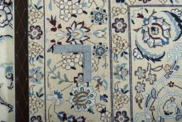 Backside of handmade 2000s Nain rug showing knot structure and weave density