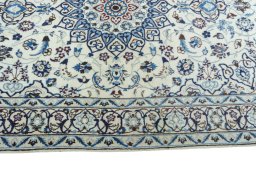 Corner detail of 2000s Nain rug showing border pattern and Wool pile