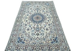 Surface texture of 2000s Nain rug with natural Wool and intricate pattern