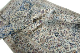 Surface texture of 2000s Nain rug with natural Wool and intricate pattern