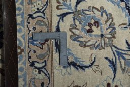 Backside of handmade New Nain rug showing knot structure and weave density
