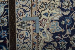 Backside of handmade 2000s Nain rug showing knot structure and weave density