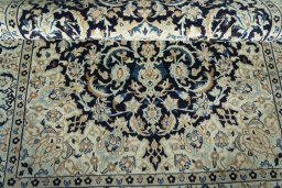 Corner detail of 2000s Nain rug showing border pattern and Wool pile