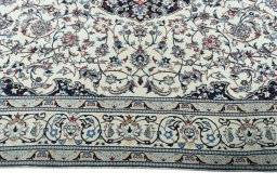 Corner detail of 2000s Nain rug showing border pattern and Wool pile