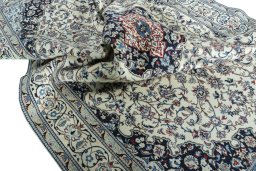 Surface texture of 2000s Nain rug with natural Wool and intricate pattern