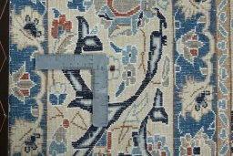 Backside of handmade 2000s Nain rug showing knot structure and weave density