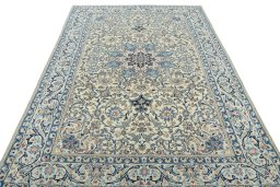 Surface texture of 2000s Nain rug with natural Wool and intricate pattern