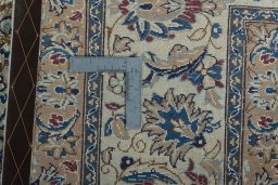 Backside of handmade 2000s Nain rug showing knot structure and weave density
