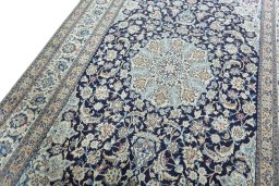 Backside of handmade 2000s Nain rug showing knot structure and weave density